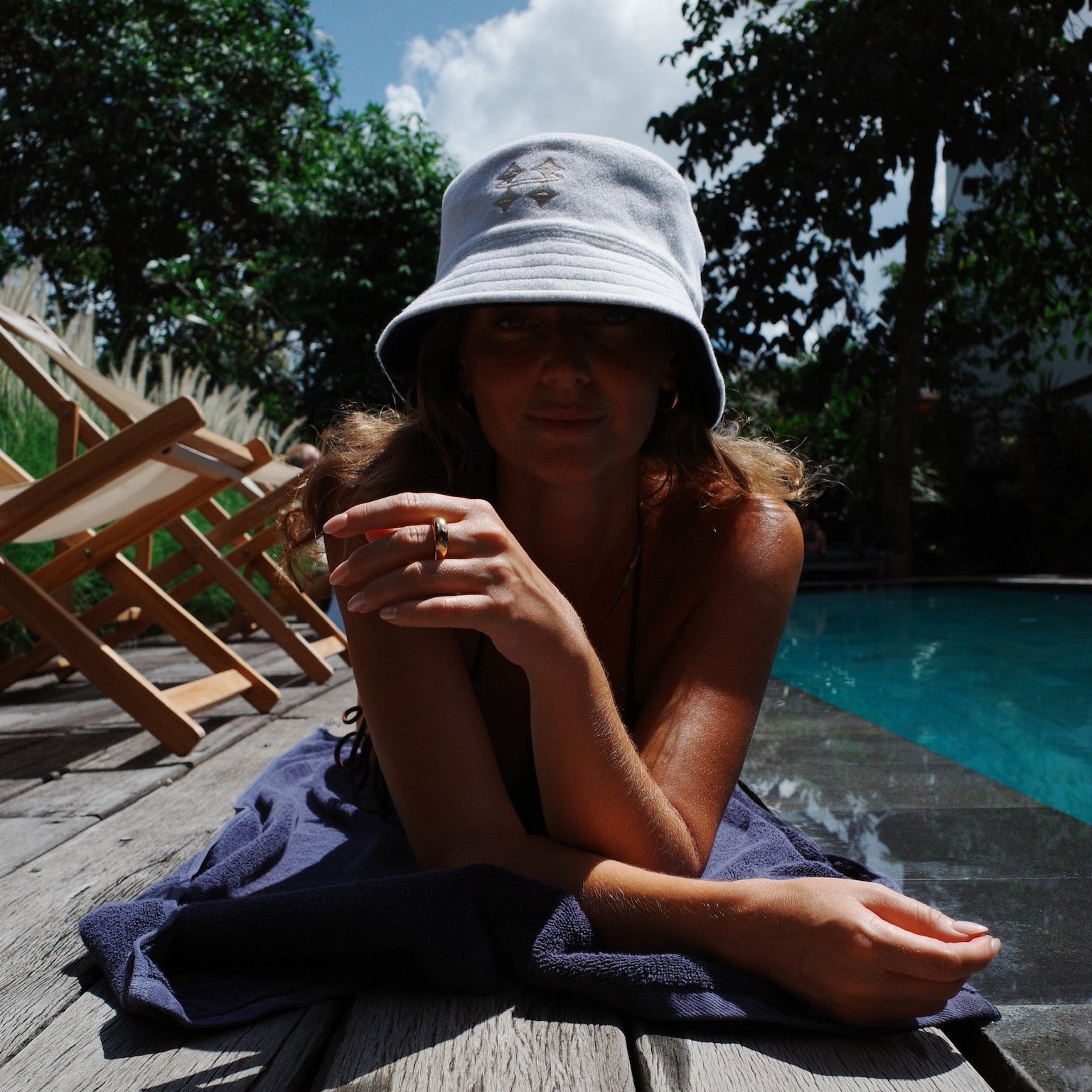 Woman laying down wearing Halo sauna hat