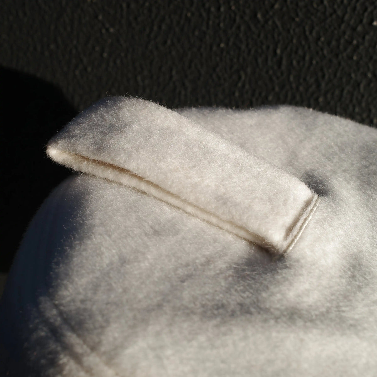 Close-up detail of Halo sauna hat wool felt hanging loop