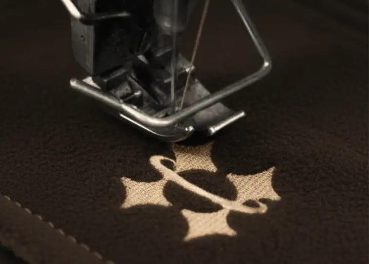 Close-up of a sewing machine needle piercing Halo sauna hat