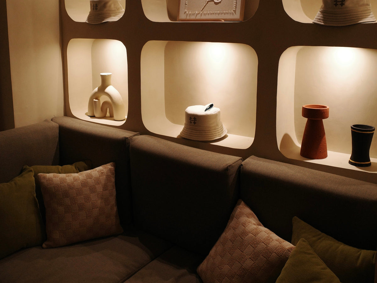 dimly lit lounge room with Halo sauna hat placed on shelf